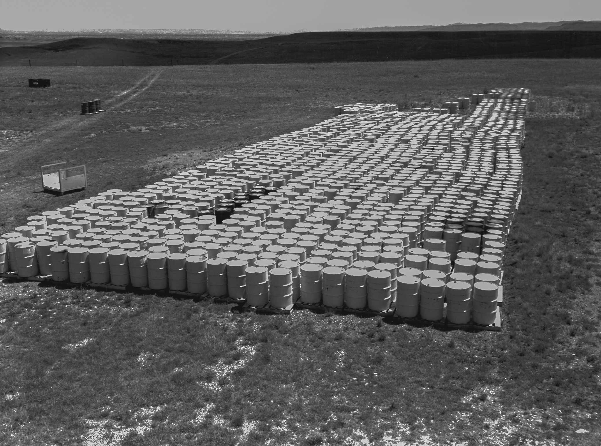 Waste drums stored outside between 1958 - 1967  leaked 5,000 gallons of cutting oils contaminated with plutonium, americium and uranium at the Rocky Flats plant, Arvada, CO (Photo: Office of Legacy Management, Department of Energy, 1962).